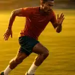 dynamic soccer player sprinting on grass field symbolizing soccer endurance training passion and energy